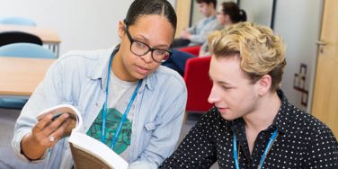 tutor showing a student a book