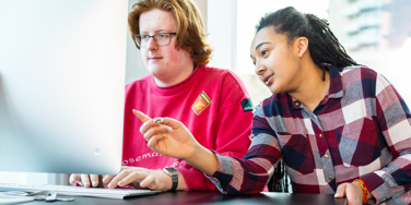 Two University Centre Leeds students working on a computer together