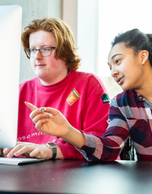 Two University Centre Leeds students working on a computer together