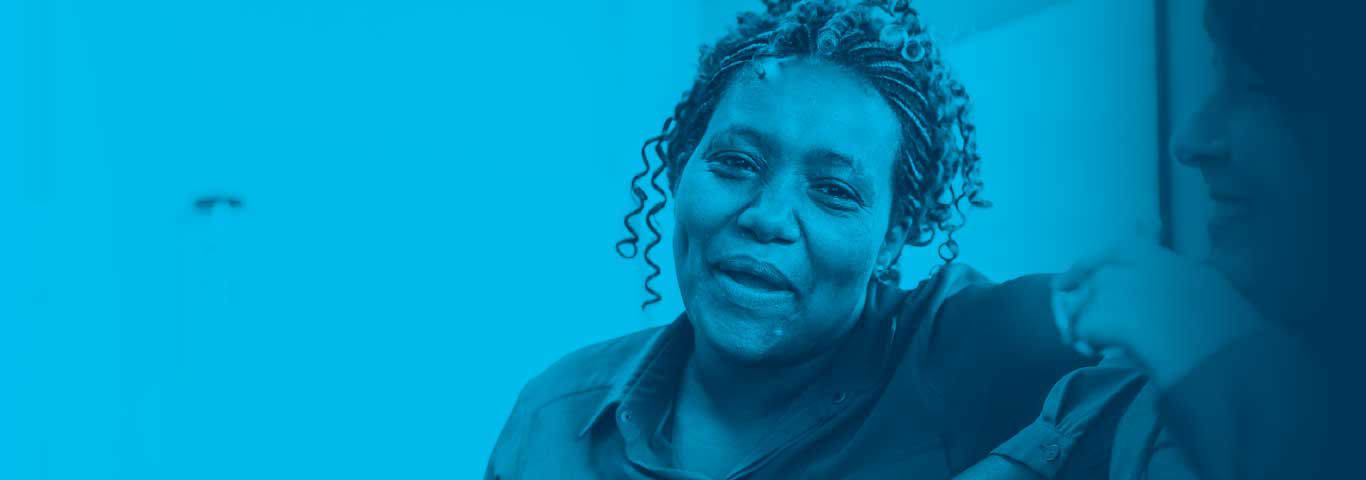 person leaning on sofa smiling, blue overlay