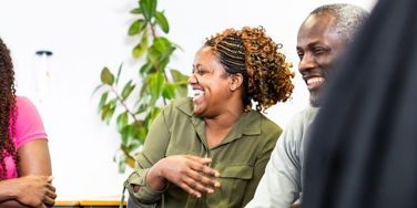Students sat in a class smiling