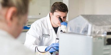 science student looking through a microscope