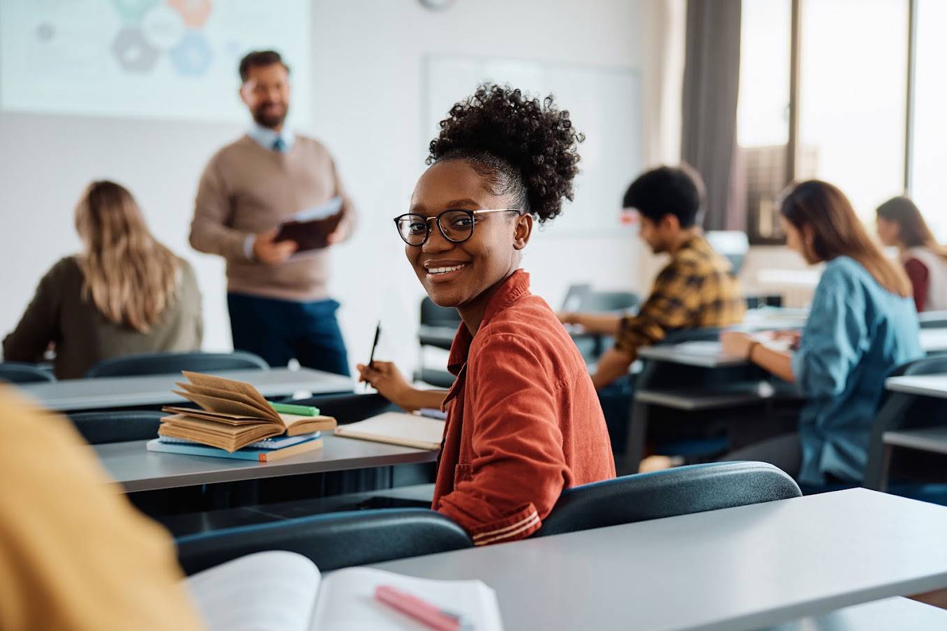Student turns to back of class smiling during lecture