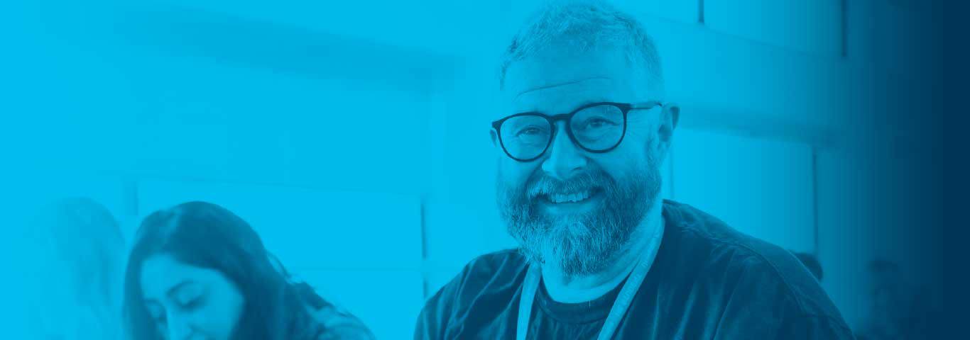 student smiling with a blue overlay